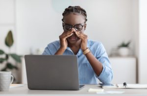 Woman tired at her computer