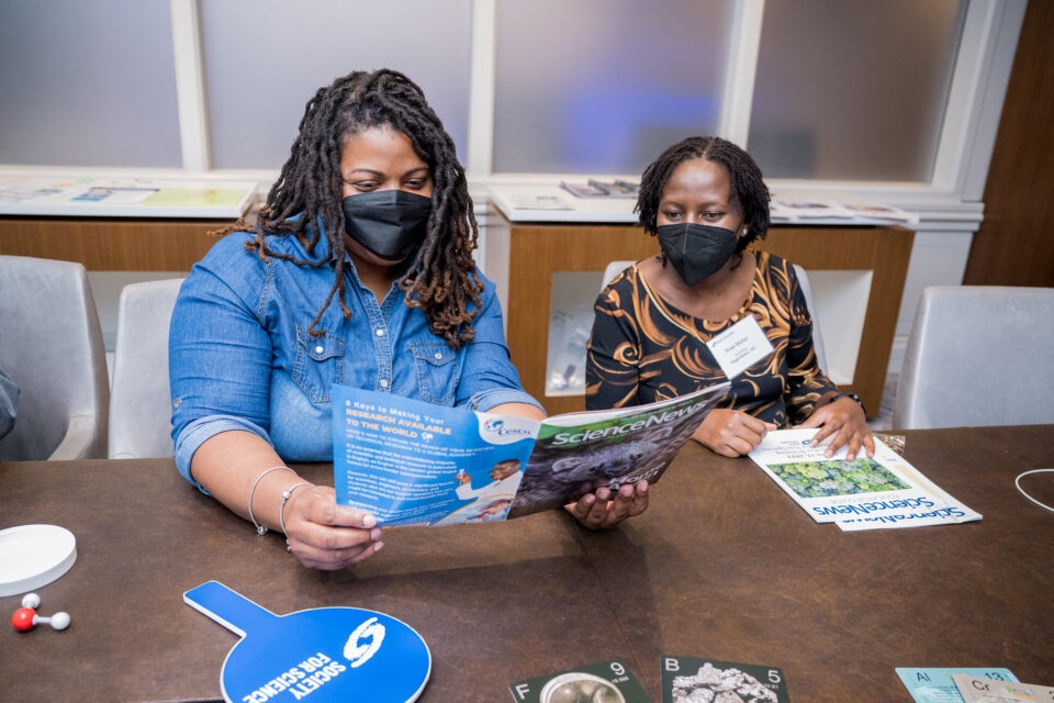 Two teachers reading a Science News magazine