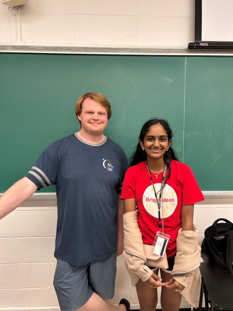 Amritha standing beside one of her research mentors.