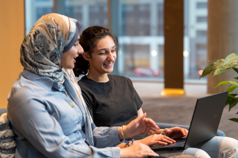 Two STS finalists look at a laptop together