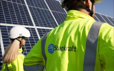 two engineers in Stakraft branded high vis jackets stand by a solar panel