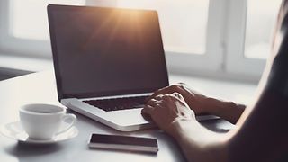 Laptop, mobile phone and coffee cup on the table