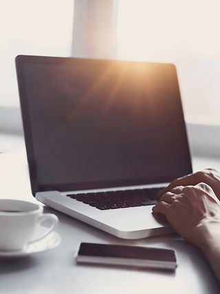 Laptop, mobile phone and coffee cup on the table