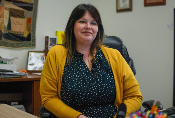 A photo of Tammie Sinclair at a desk.