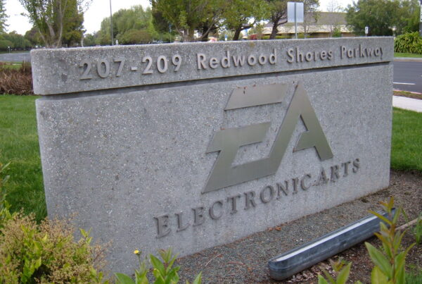 An outdoor stone sign with a silver "EA" logo and the words "Electronic Arts" and "207-209 Redwood Shores Parkway"