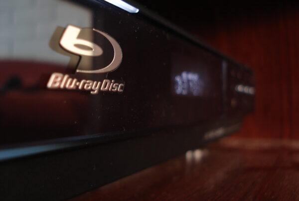 A close-up of a black Blu-ray player with a silver "Blu-ray Disc" logo