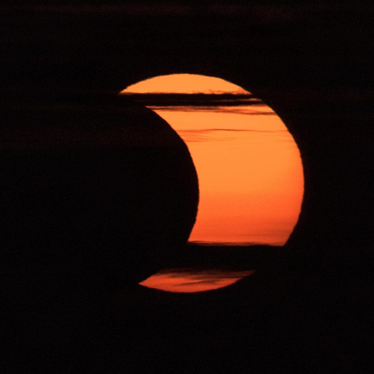 A partial solar eclipse is seen from Arlington, Virginia, Thursday, June 10, 2021. The annular or “ring of fire” solar eclipse is only visible to some people in Greenland, Northern Russia, and Canada. Photo Credit: (NASA/Bill Ingalls)