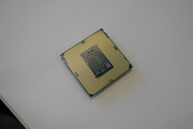 Intel Core i7-7700K 1Intel Core i7-7700K CPU on a white surface.