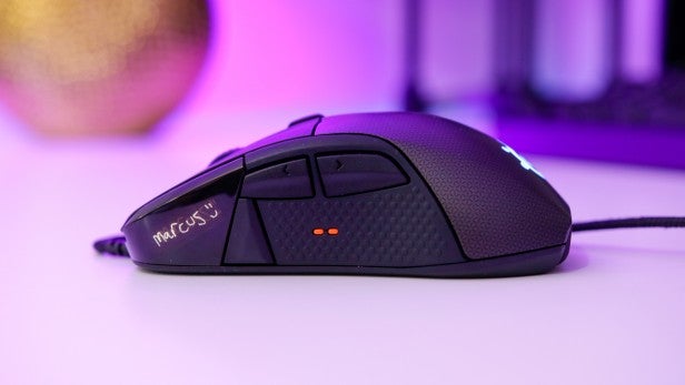 RivalSteelSeries Rival 700 gaming mouse on a desk with RGB lighting.