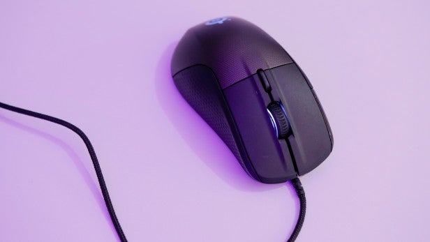 RivalSteelSeries Rival 700 gaming mouse on a pink surface.