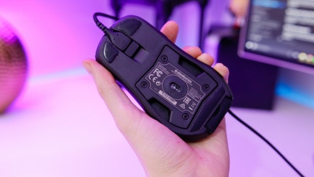 RivalHand holding a SteelSeries Rival 700 gaming mouse showing underside.