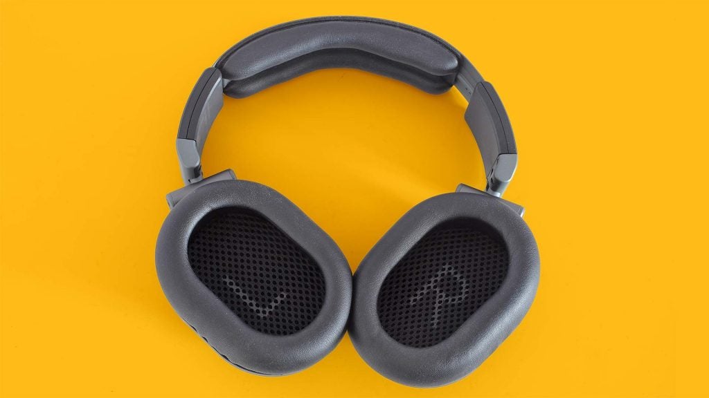 Austrian Audio Hi-X55View from top of gray-black Hi-X55 headphones resting on a solid-yellow background, earcups inside view