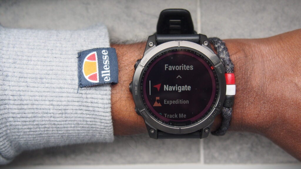 Garmin Fenix 7 showing favourites, including navigationGarmin Fenix 7 watch on wrist displaying menu options.