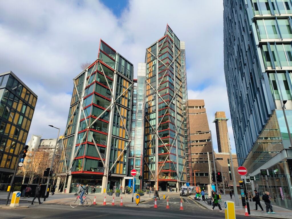 Modern buildings and street in urban setting.Modern buildings and busy urban street scene.