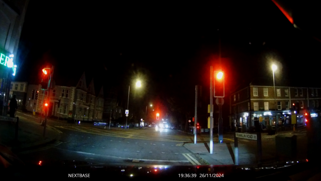 Video still frame waiting at city-centre traffic lights at night