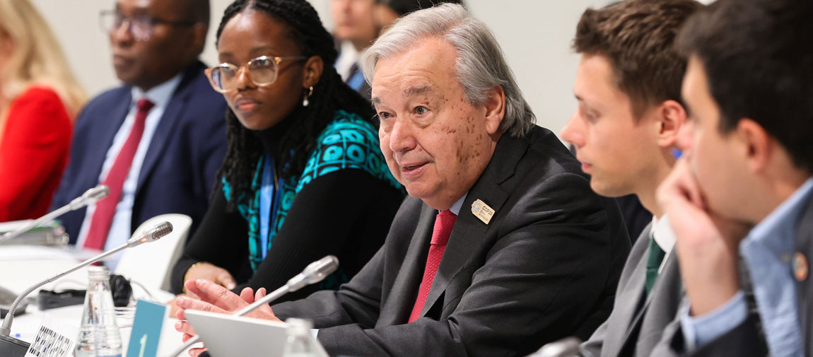 Secretary-General António Guterres speaks with young climate advocates at COP29 at COP29 in Baku, Azerbaijan. © UN Office for Partnerships