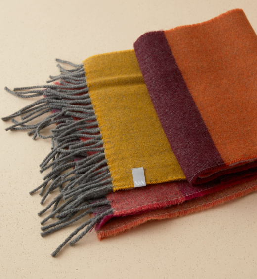 Orange, yellow and pink wool scarves.