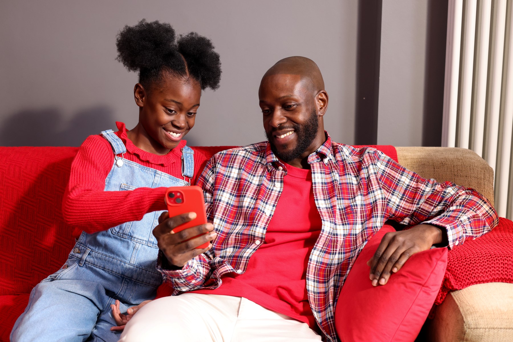 Father and daughter looking a smartphone