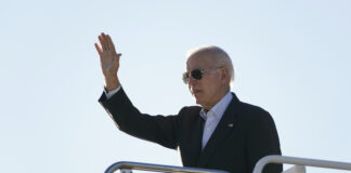 President Joe Biden waves before boarding Air Force One at El Paso International Airport in El Paso, Texas, Sunday, Jan. 8, 2023, to travel to Mexico City, Mexico.