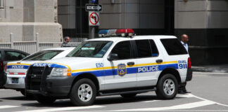 Philadelphia - June 11, 2013: A person walks by a Philadelphia Police Ford Explorer.