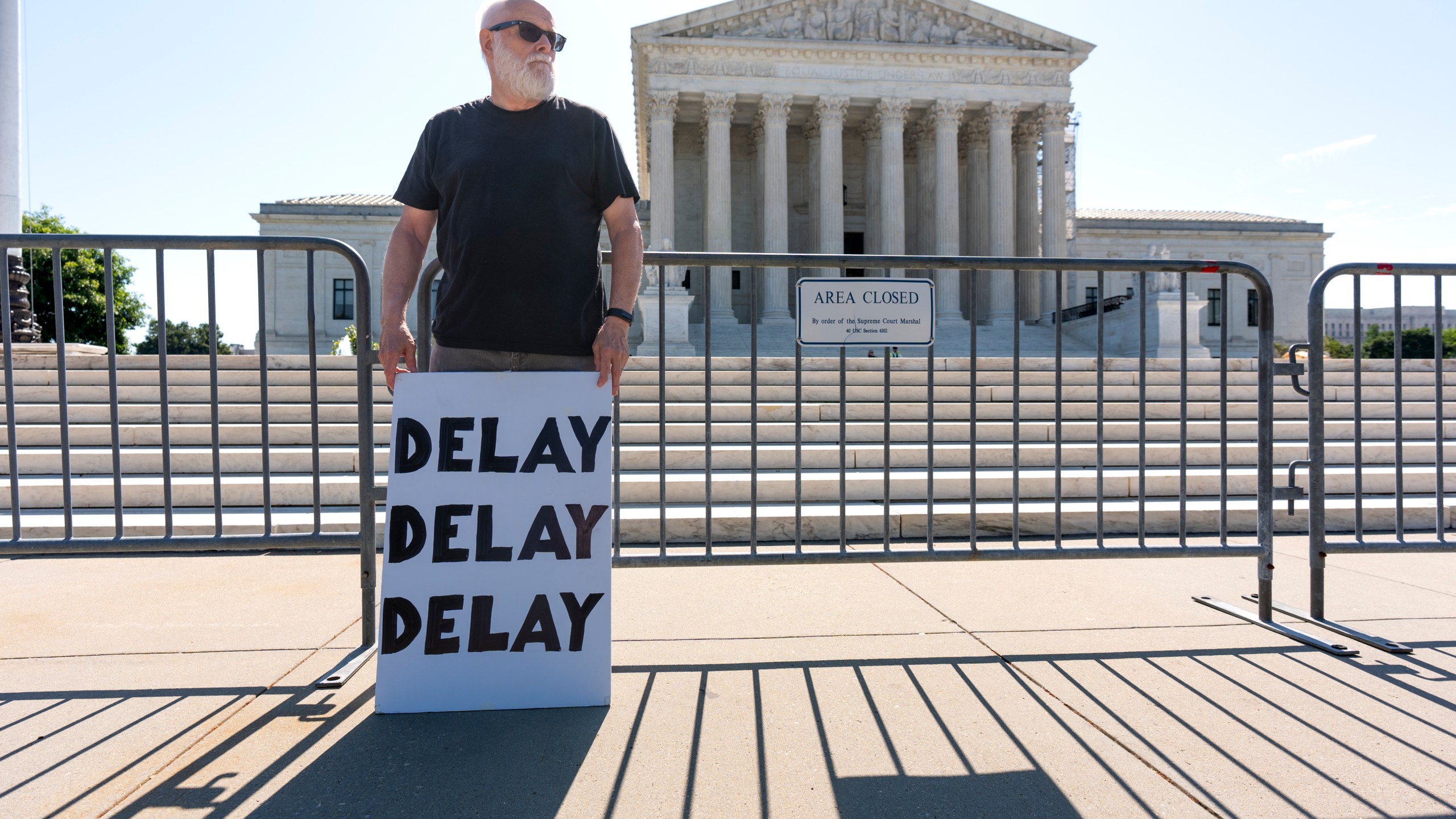 Activist Bill Christeson protests in front of the Supreme Court as decisions are announced, on Capitol Hill in Washington, Friday, June 21, 2024. The justices are still weighing whether former President Donald Trump is immune from criminal prosecution in the election interference case against him, roughly two months after hearing arguments. (AP Photo/J. Scott Applewhite)