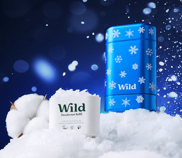 stock photo of wild deodorant laying atop snow with a blue background