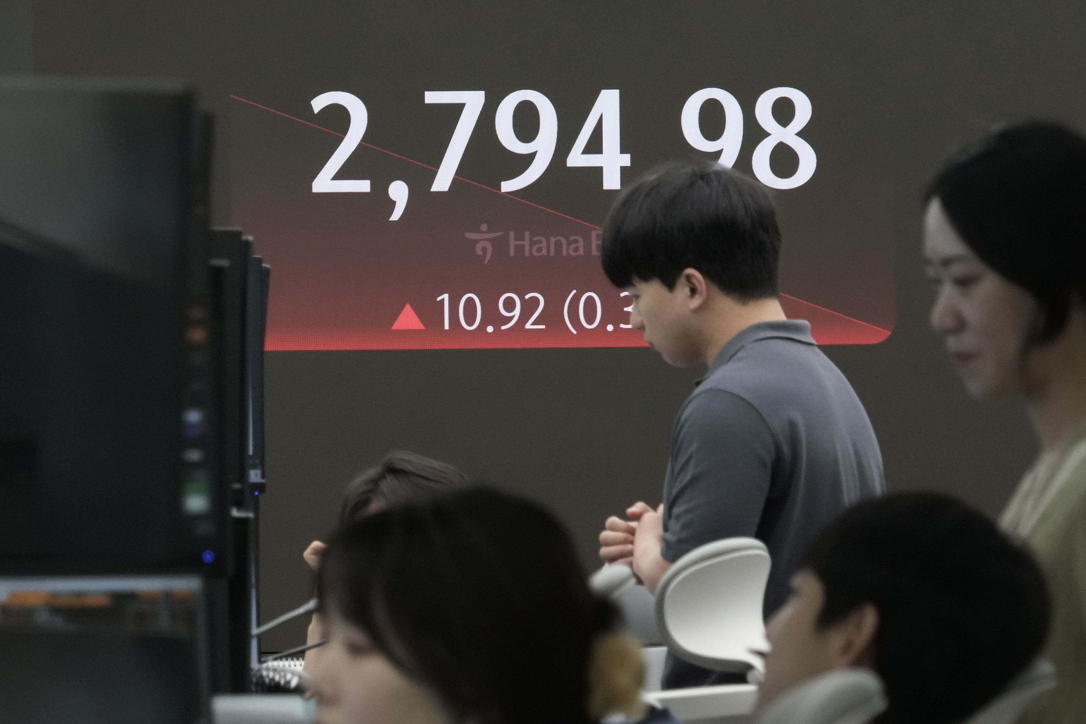 Currency traders watch monitors near the screen showing the Korea Composite Stock Price Index (KOSPI) at the foreign exchange dealing room of the KEB Hana Bank headquarters in Seoul, South Korea, Friday, June 28, 2024. (AP Photo/Ahn Young-joon)