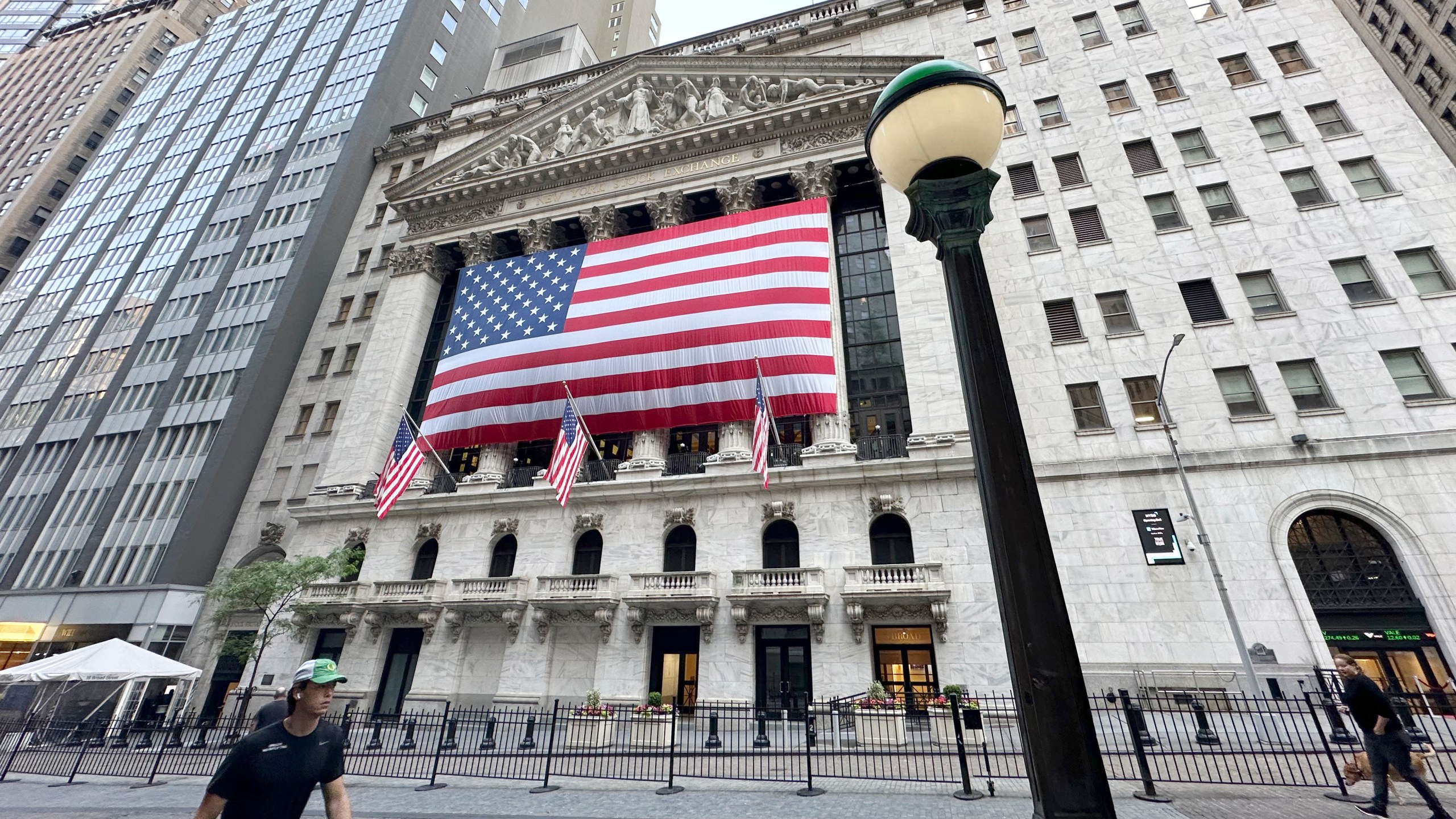 File - People pass the New York Stock Exchange on May 28, 2024, in New York. Global shares have advanced on Friday, June 28, 2024, as traders look ahead to a key report on inflation that could influence the Federal Reserve's next move on interest rates. (AP Photo/Peter Morgan, File)