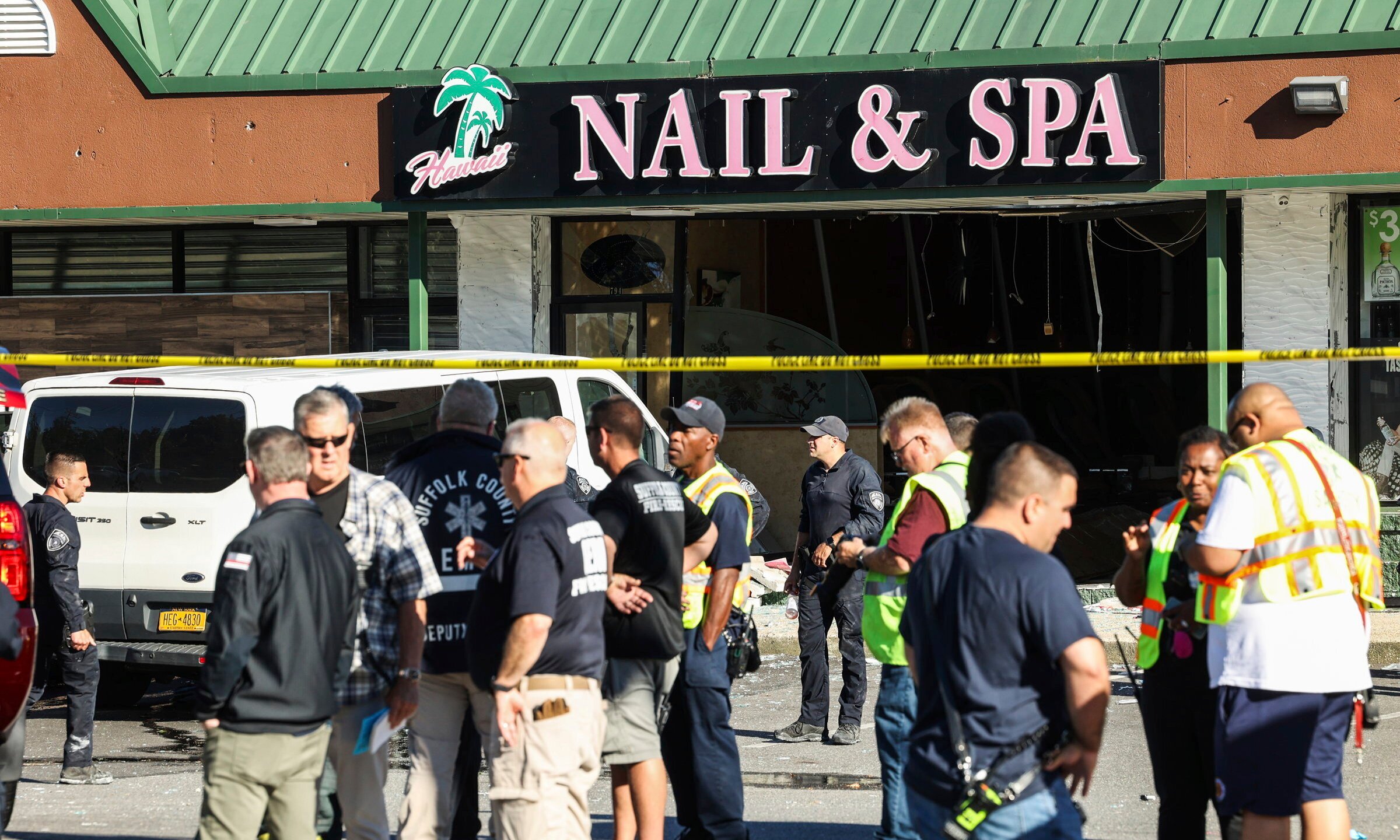 Emergency personnel respond to a scene after a vehicle drove into Hawaii Nail & Spa, killing and injuring multiple people Friday, June 28, 2024, in Deer Park, N.Y. (Steve Pfost/Newsday via AP)