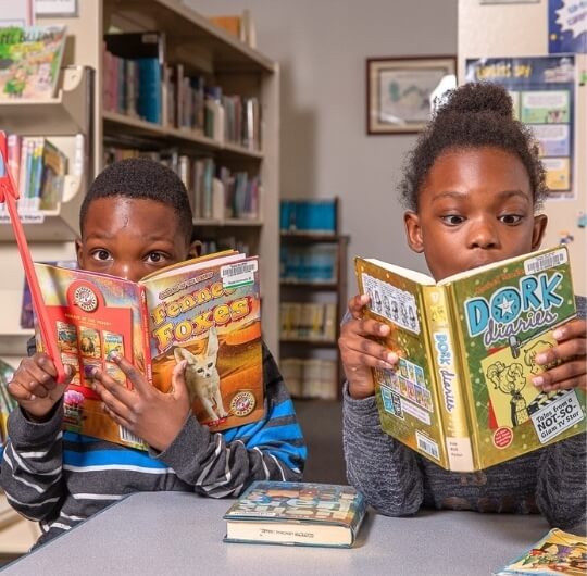 Boy And Girl Reading Chapter Books At Glatfelter Library