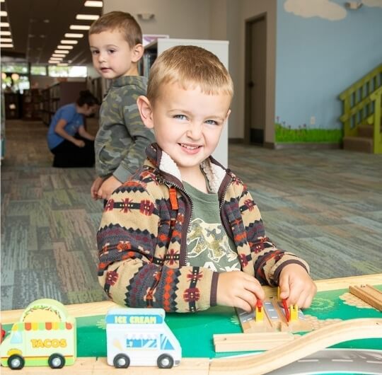 Boy Playing With Toys At Kaltreider Benfer Library