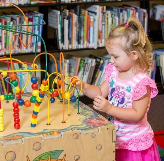 Girl Playing With Puzzle At Mason Dixon Library