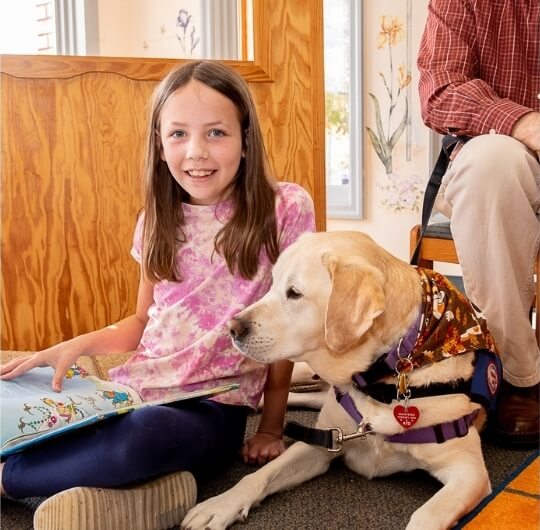 Girl Reading To Therapy Dog At Glatfelter Library Tales For Tails Program