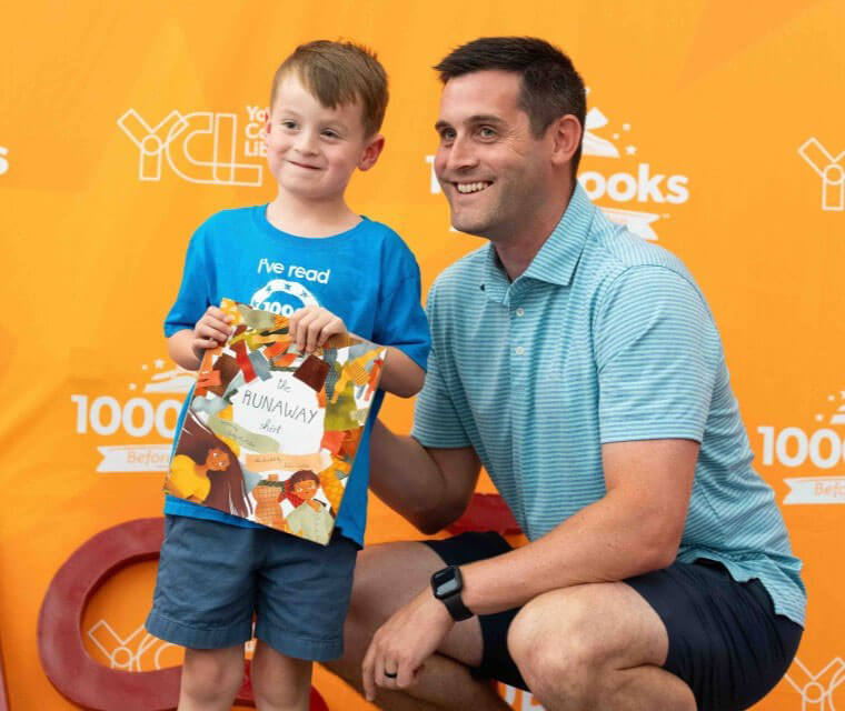 Father And Son Posing For 1000 Books Before Kindergarten Award