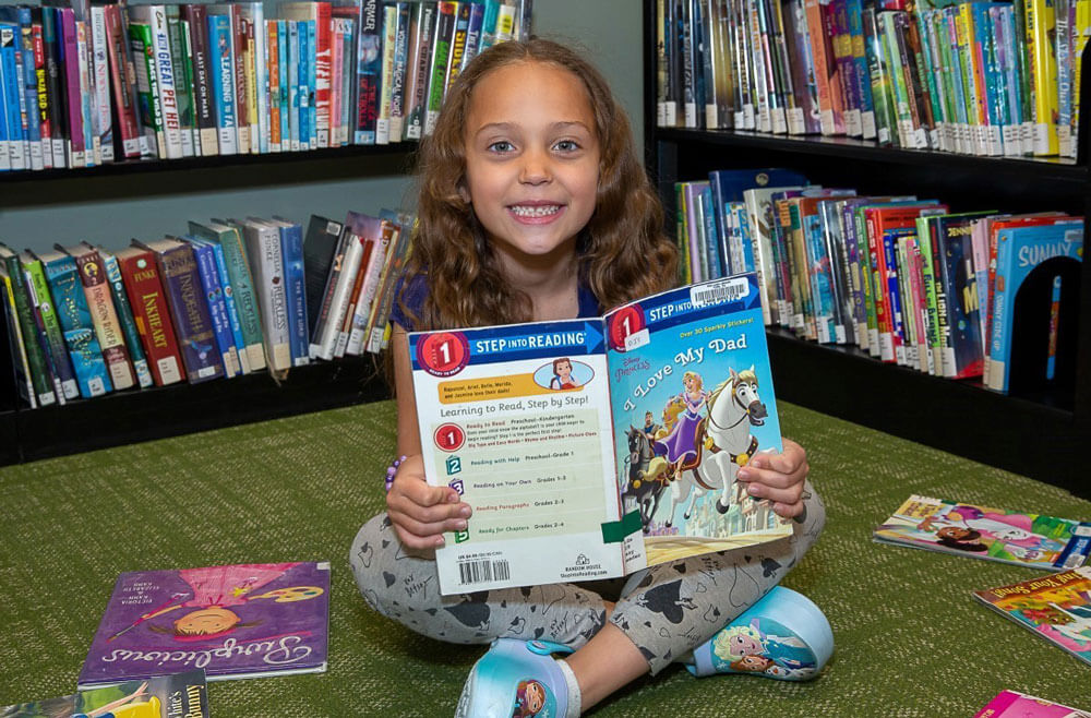 First Grader Reads A Book On Her Own