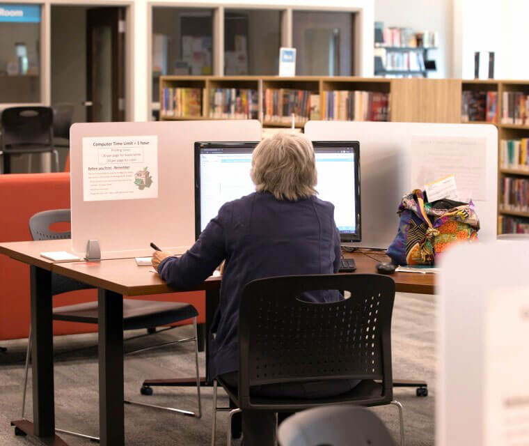 Woman Using Computer At Library